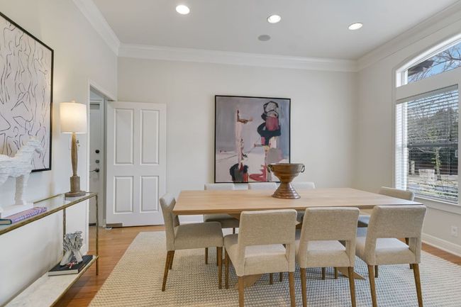 Dining area with room for a large dining table, crown molding, high ceilings and recessed lighting. | Image 5