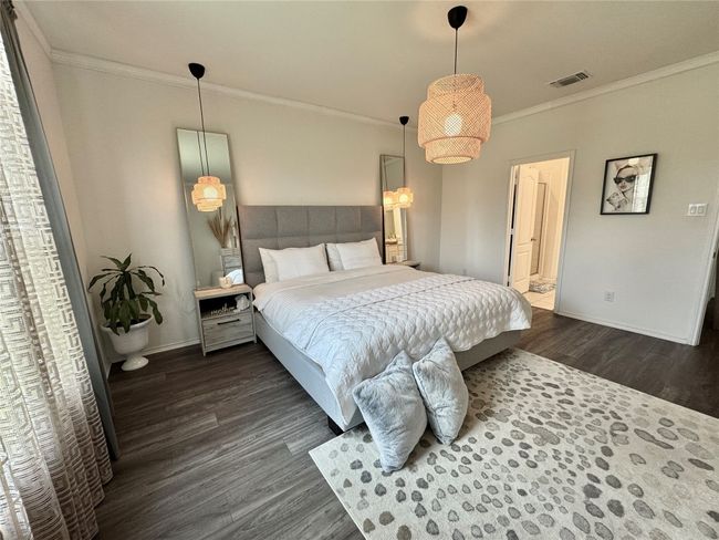 Bedroom featuring dark wood-style floors and crown molding | Image 18