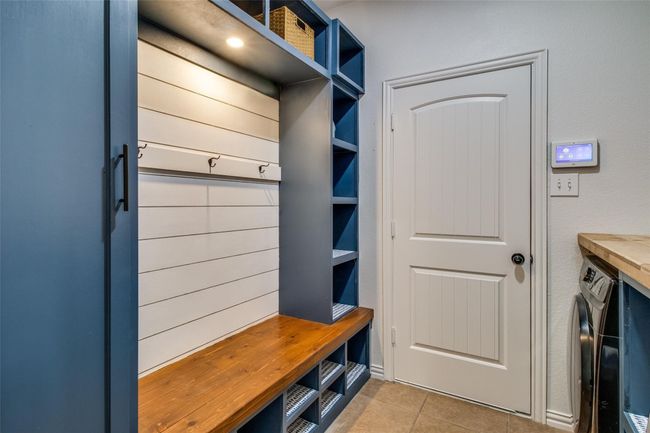 Mudroom featuring light tile patterned floors and washer / dryer | Image 21