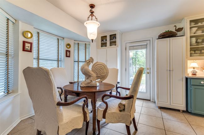 Dining room with light tile patterned floors and baseboards | Image 16