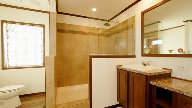Bathroom with toilet, vanity, walk in shower, and wood finished floors | Image 11