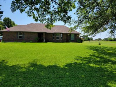 Ranch-style home featuring a front lawn | Image 1