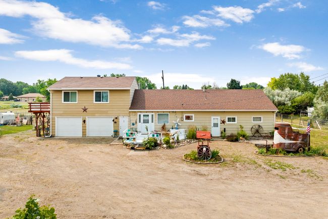 Rear view of house featuring a wooden deck, fence, an attached garage | Image 91