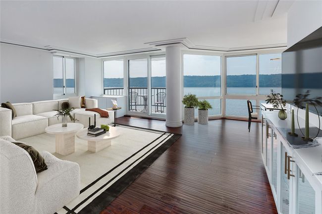 Unfurnished sunroom with plenty of natural light, a water view, and a chandelier | Image 8