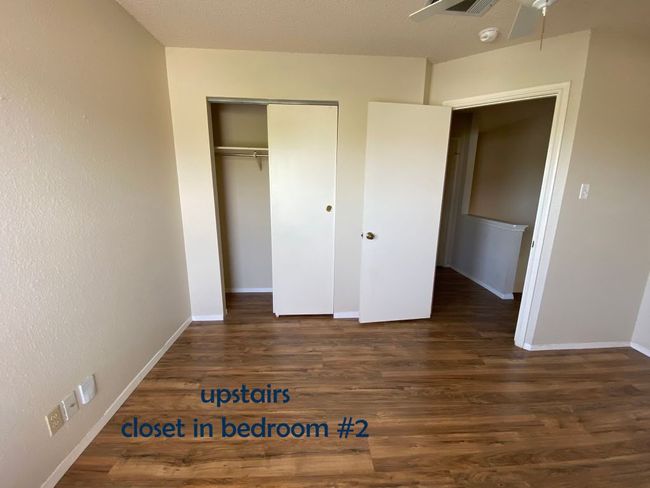 Bedroom with vinyl floors, ceiling fan, and a closet | Image 15