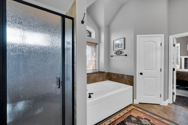 Bathroom featuring shower with separate bathtub and tile patterned floors | Image 16