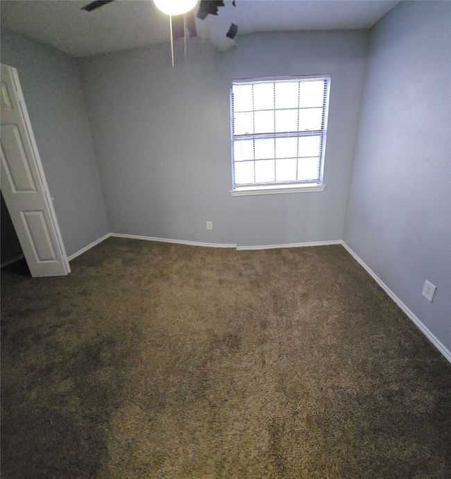 Spare room with ceiling fan and dark colored carpet | Image 20