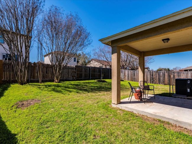 The large fenced-in backyard provides plenty of space to play and grow, highlighted by two crepe myrtle trees that burst into colorful blooms during the summer. | Image 26