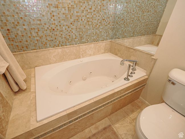 Full bath with a tub with jets and tile patterned floors | Image 31