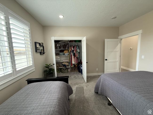 Carpeted bedroom with baseboards, a closet, and a textured ceiling | Image 55