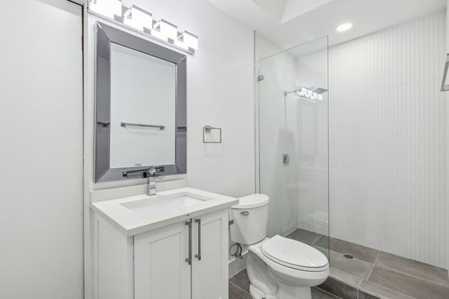 Full bath with tile patterned floors, toilet, vanity, and walk in shower | Image 19
