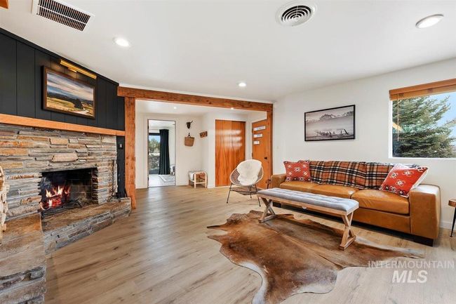Living room with light wood finished floors, recessed lighting, and a fireplace | Image 28