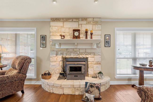 Living area featuring crown molding and wood finished floors | Image 6