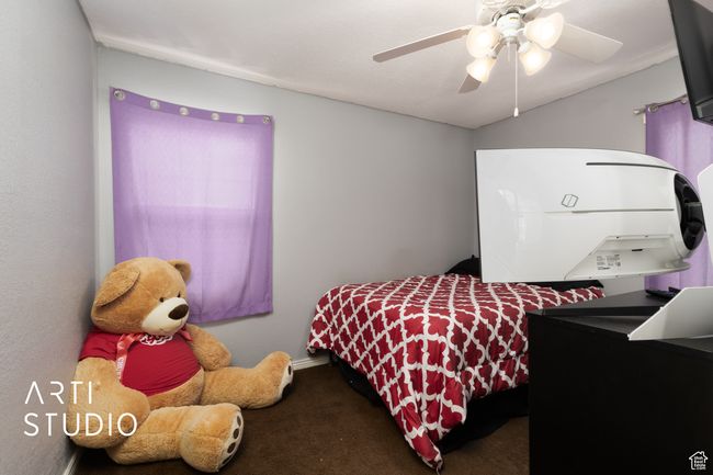 Bedroom with carpet flooring and a ceiling fan | Image 44
