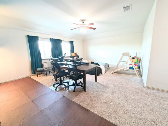 Dining room featuring a ceiling fan, an office area, and carpet | Image 8