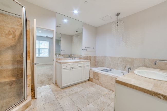 Full bath with vanity, a bath, a stall shower, and tile patterned floors | Image 12