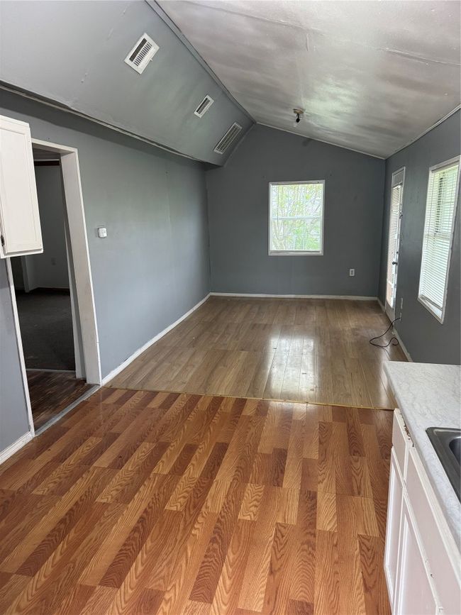 Bonus room featuring wood finished floors, vaulted ceiling, and visible vents | Image 5