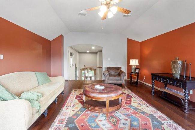 Upstairs elevated gameroom with a small step up, continues with the same hardwood flooring. | Image 22