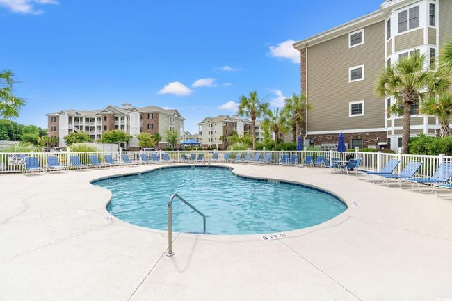 Community pool with a patio | Image 25