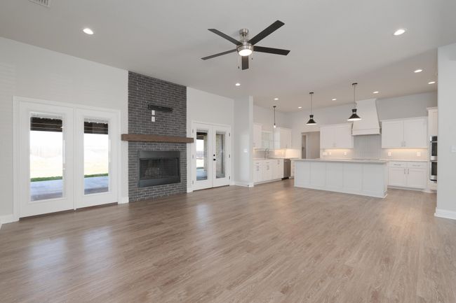 Unfurnished living room with a wealth of natural light, recessed lighting, light wood-style floors, and ceiling fan | Image 18