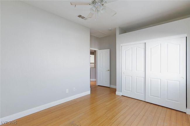 Unfurnished bedroom featuring light wood-style floors, a closet, a ceiling fan, visible vents, and baseboards | Image 37