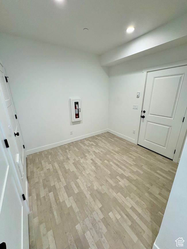 Laundry room with light wood finished floors and recessed lighting | Image 10