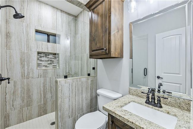 Full bath featuring a tile shower and vanity | Image 10