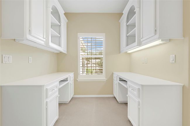 Expansive dual workstation with ample cabinetry, perfect for productivity and organization. | Image 34
