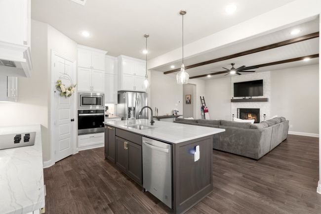 Kitchen featuring stainless steel appliances, ceiling fan, dark wood-style flooring, white cabinets, and recessed lighting | Image 9