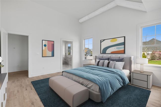 Bedroom with high vaulted ceiling, baseboards, ensuite bath, and light wood finished floors | Image 10