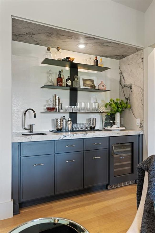 The wet bar is an entertainer's dream. Luxurious Kohler fixtures have been selected to accentuate the Neotlith counter tops and wall. One will find an integrated Thermador beverage refrigerator for your favorite wine or Topo Chico storage. | Image 14