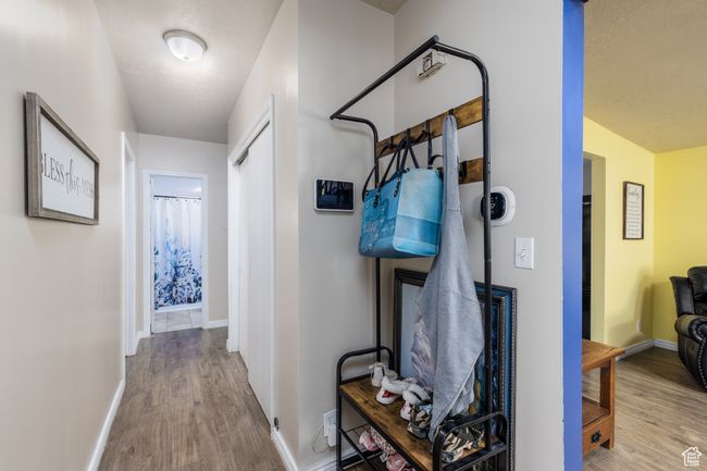Hallway featuring wood finished floors and baseboards | Image 11