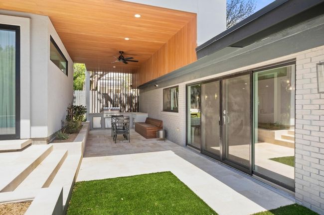 View of patio / terrace with fence, an outdoor kitchen, and ceiling fan | Image 28