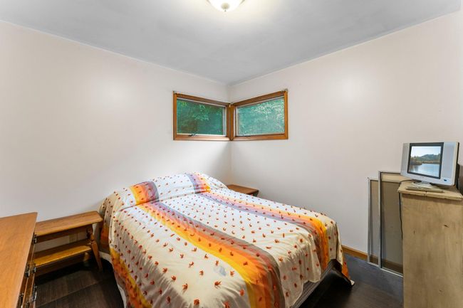 A well-sized bedroom offers stylish flooring and closet storage. | Image 21