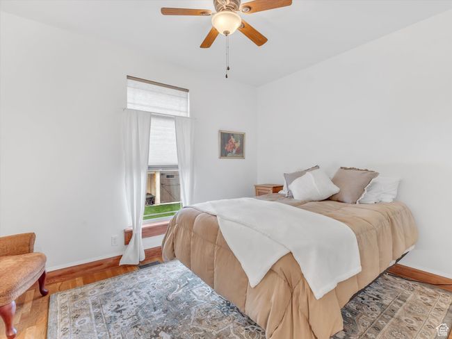 Bedroom with baseboards, a ceiling fan, and wood finished floors | Image 24