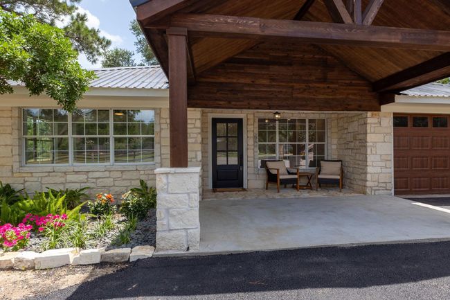 Welcoming covered entryway with charming seating area. | Image 8
