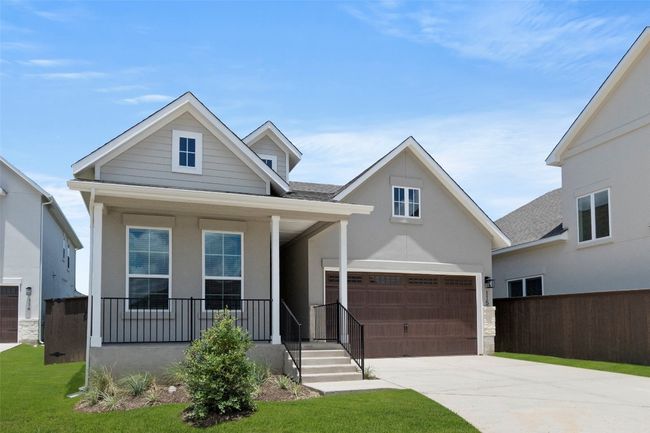 View of front of house with driveway, covered porch, a garage, and a shingled roof | Image 4