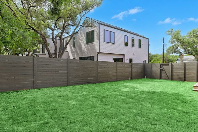 View of fenced backyard | Image 25