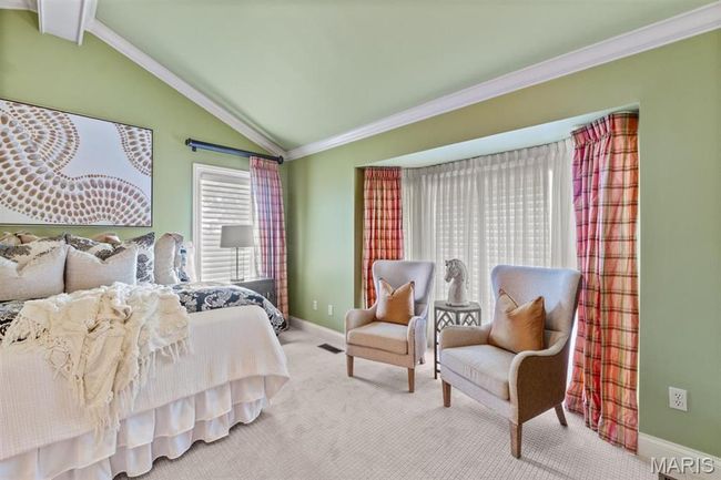 Carpeted bedroom featuring vaulted ceiling and crown molding | Image 36