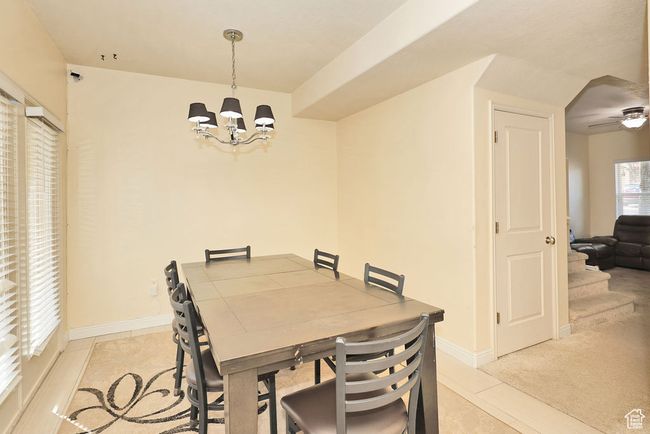 Dining area featuring an inviting chandelier and baseboards | Image 16