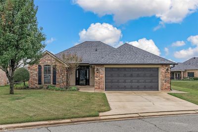 Front exterior view featuring a nice front entrance with custom glass storm door and easy care landscaping. | Image 1