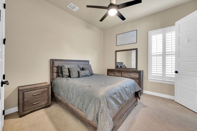 Bedroom featuring light carpet and ceiling fan | Image 23