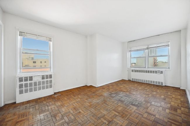 Spare room with baseboards and radiator heating unit | Image 10