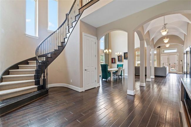 Towering rounded grand staircase to the game room, media room and additional 3 bedrooms upstairs. | Image 8