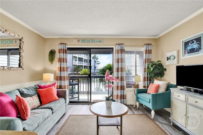Open Living Area with Sleeper Sofa & Plenty of Natural Light Plus Access to Private Outdoor Balcony with Sunset & Partial Water Views! | Image 4