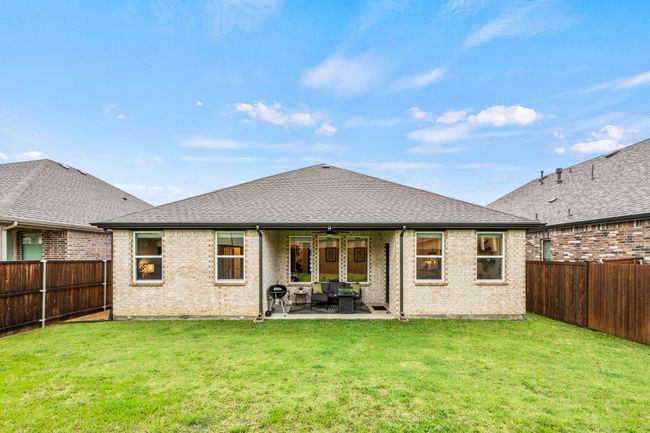 Rear view of house with a ceiling fan, a patio, brick siding, an outdoor living space, and a shingled roof | Image 22