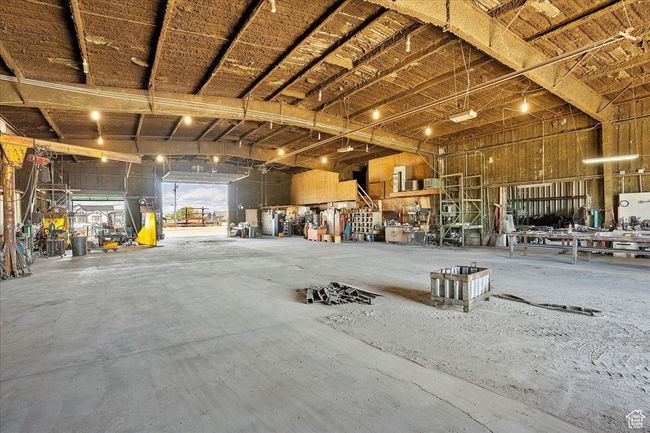 Misc room with a workshop area and a garage | Image 8