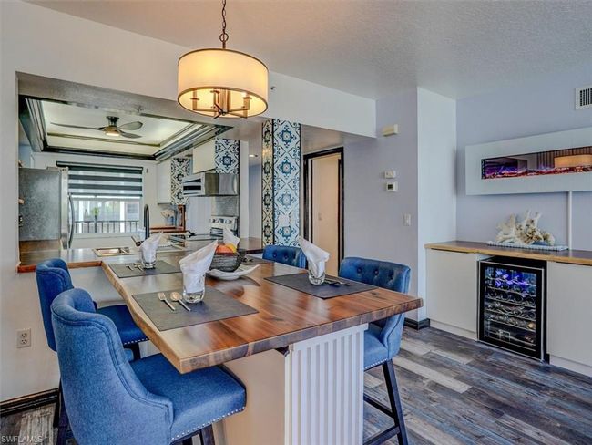 CUSTOM DINING EXTENSION. CUSTOM DINING AREA CABINET W/ACACIA WOOD TOP, BEVERAGE CENTER AND WALL-MOUNTED ELECTRIC FIREPLACE. ENTRANCE TO GUEST BEDROOM AND BATH IS SHOWN MIDDLE REAR. | Image 8