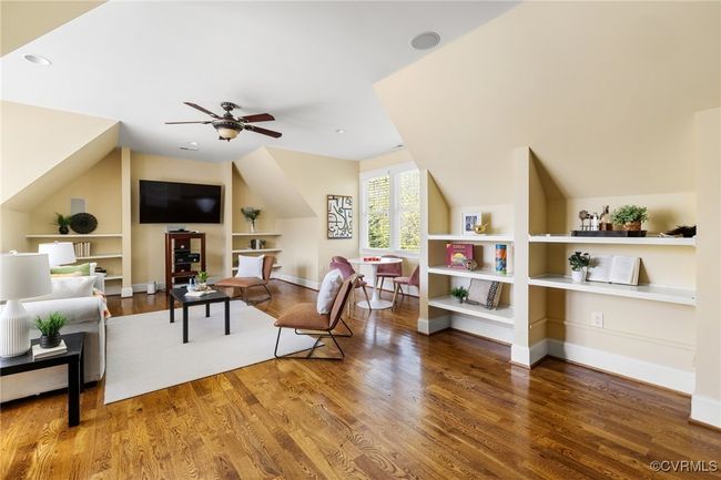 Site finished hard wood floors, surround sound, recessed lighting, ceiling fan with light, built in shelving. | Image 27