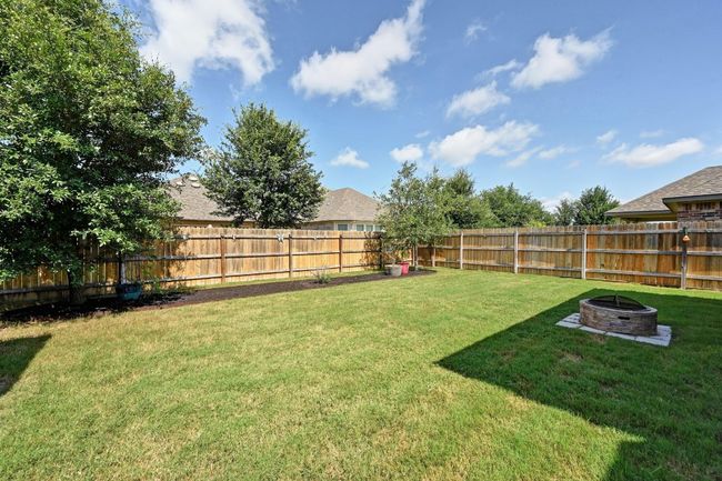 Fenced backyard featuring a fire pit | Image 30